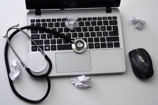 Laptop computer with stethoscope — virus removal and diagnostics by Candid Computers